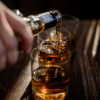 pouring-strong-alcohol-drink-into-glasses-which-are-wooden-table.jpg image 1